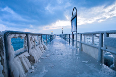 Jetty at calm sea during winter