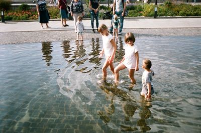 Rear view of people in water