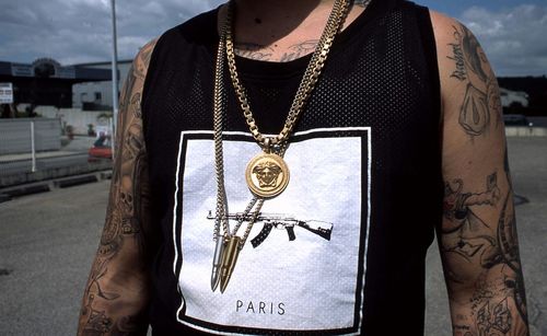 Midsection of tattooed man