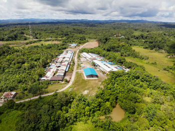 High angle view of road amidst trees against sky