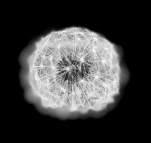 Close-up of illuminated lighting equipment against black background