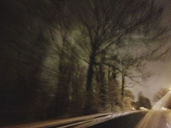 Road amidst trees against sky seen through car windshield