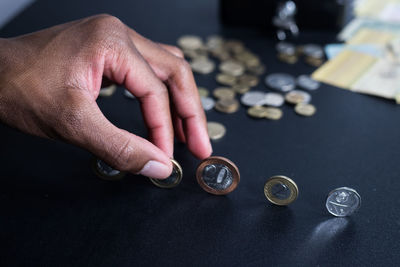 High angle view of hand holding coins