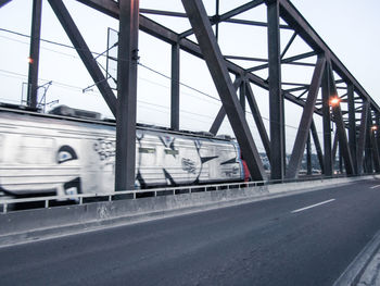 Bridge over road against sky in city