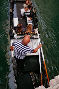 High angle view of people sitting on boat in river