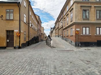 Footpath amidst buildings in city