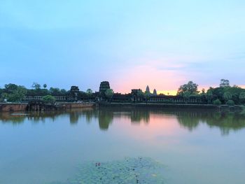 Scenic view of lake against sky at sunset