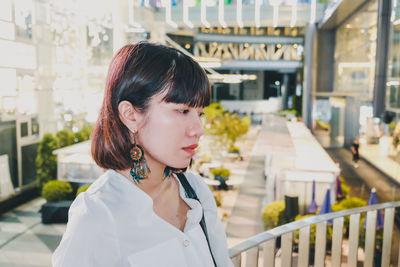 Young woman in illuminated city 