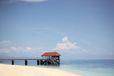 Lifeguard hut on beach against sky