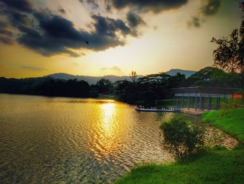 Scenic view of lake against sky at sunset