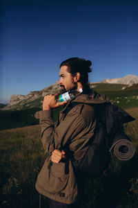 Man standing on field against clear sky