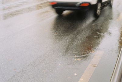 Wet car on road in rain