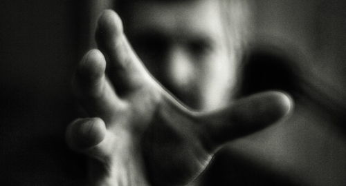 Close-up of woman hand against black background