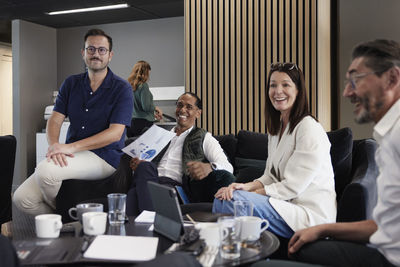 Group of business people having meeting in lobby