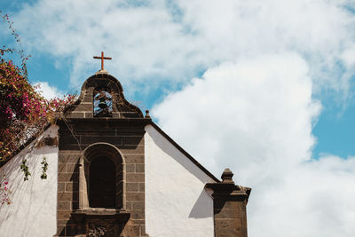 Low angle view of bell tower against sky