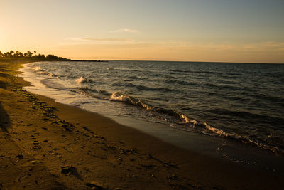 Scenic view of beach against sky during sunset