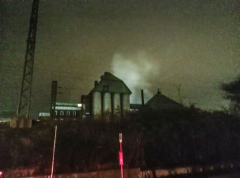 Illuminated built structure against sky at night