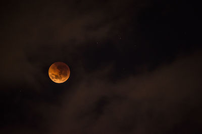 Low angle view of moon against sky at night