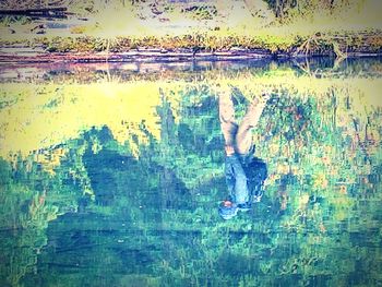 Close-up of reflection of man in water