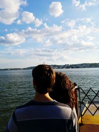 Rear view of woman in sea against sky