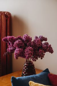 Close-up of pink flower pot on table at home