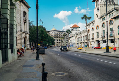 City street by buildings against sky