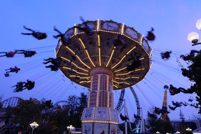 Low angle view of ferris wheel against blue sky