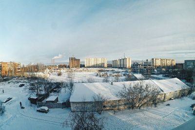 Snow covered buildings in city