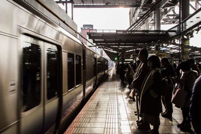 People standing at railroad station platform