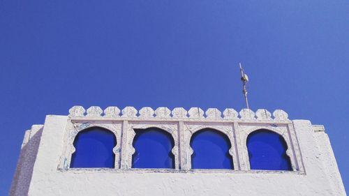 Low angle view of historic building against clear blue sky