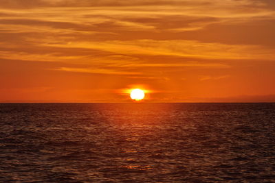 Scenic view of sea against romantic sky at sunset