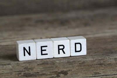 Nerd, written in cubes on a wooden background