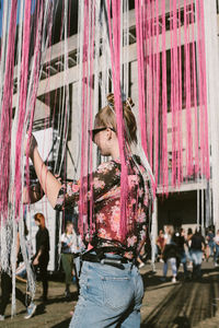 Full length of girl standing against graffiti