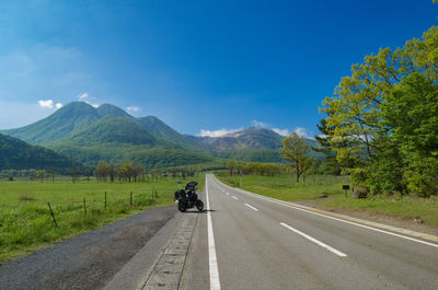 Country road leading towards mountains