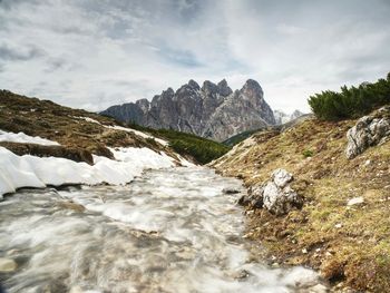 Scenic view of sea and mountains against sky