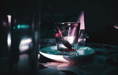 Close-up of hand holding wine glass on table