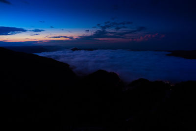 Scenic view of silhouette mountains against sky at sunset