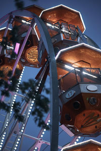 Low angle view of illuminated ferris wheel against sky at night