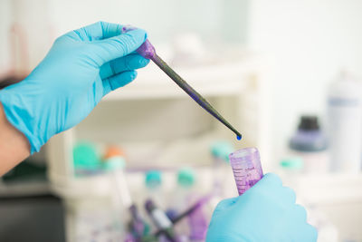 Cropped hands of scientist experimenting in laboratory