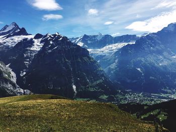 Scenic view of snowcapped mountain against cloudy sky