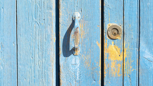 Colorful door with lock and handle.