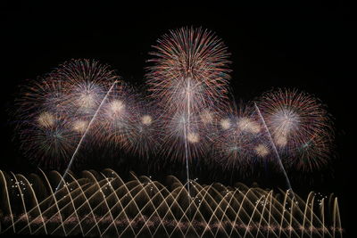 Low angle view of firework display at night