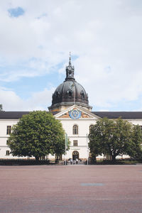 View of building and trees against sky