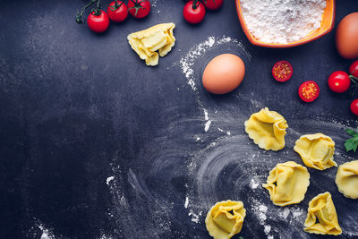 Italian pasta with ingredients and black background. gastronomic concept