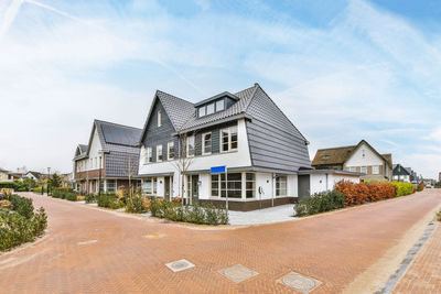 Houses on field against sky