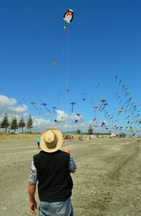 Full length of a boy jumping against blue sky