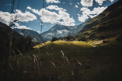 Scenic view of field and mountains against sky