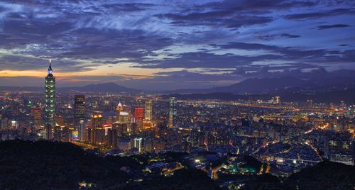 High angle view of city lit up at night