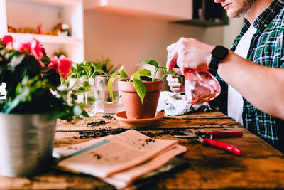 Midsection of man preparing food on table