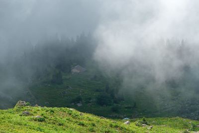 Scenic view of fog over land